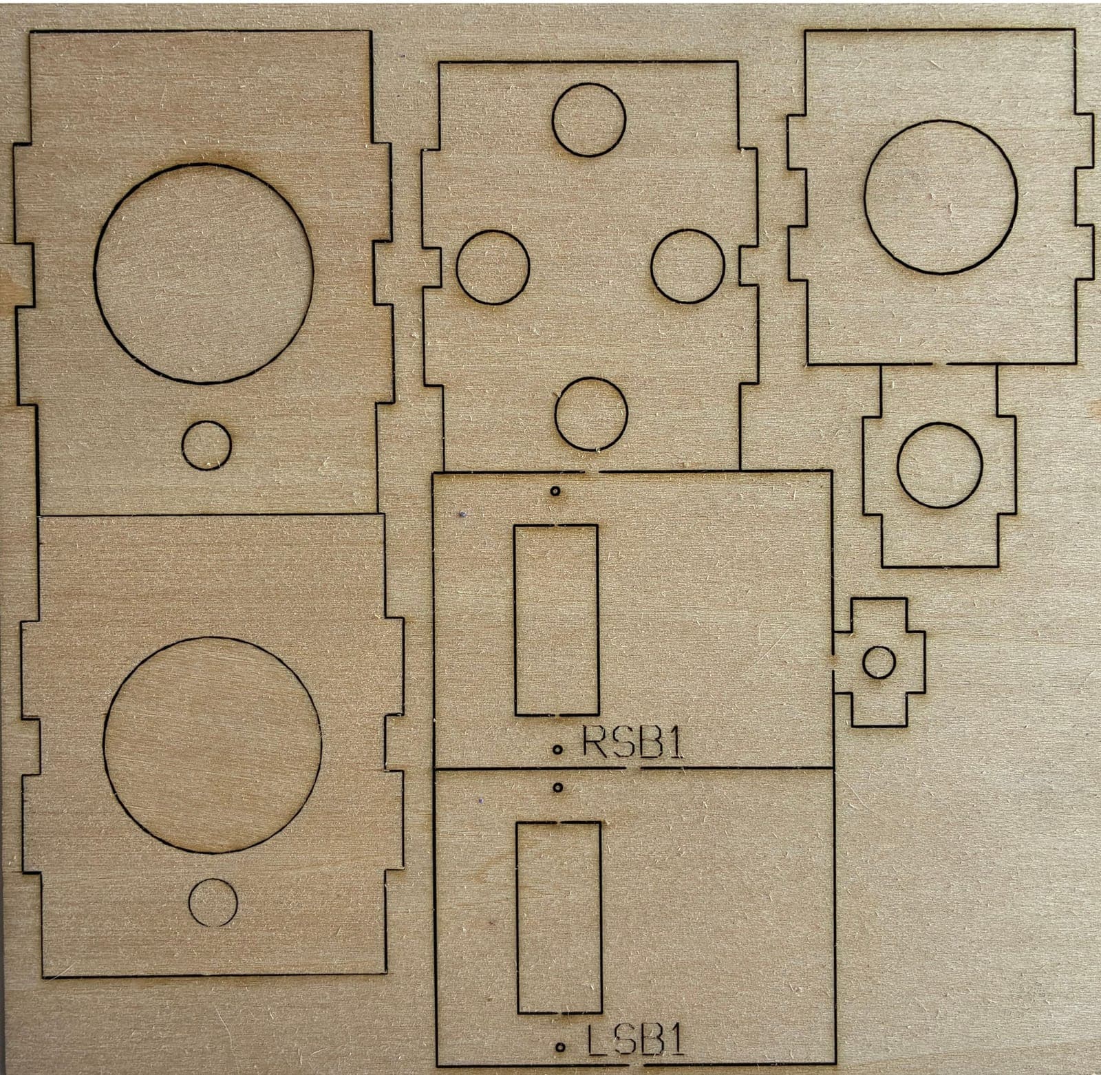 Plywood sheet with laser-cut firewall and formers, engraved part IDs