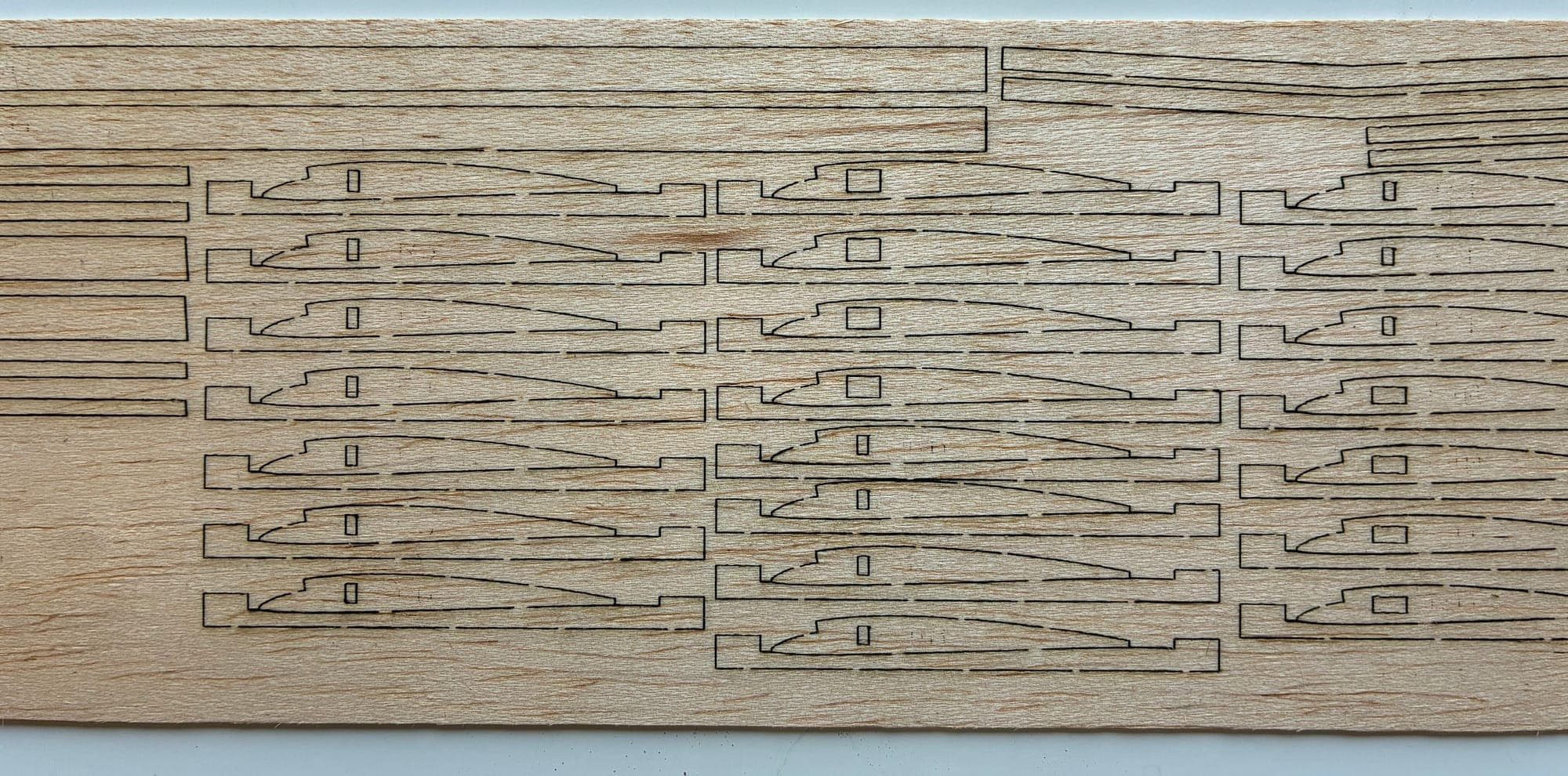 Balsa sheet with rows of wing ribs nested and held by retention tabs